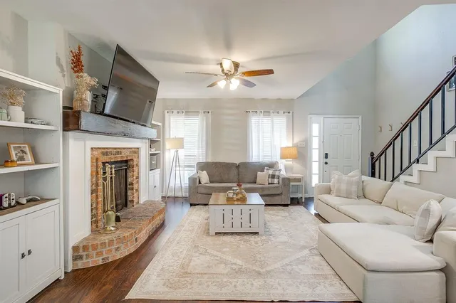 a living room with furniture fireplace and flat screen tv