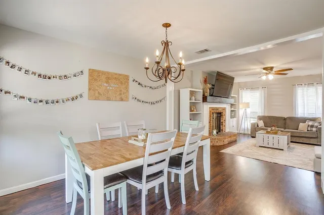 a view of a dining room with furniture wooden floor and chandelier