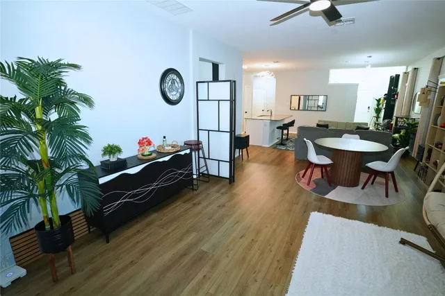 a living room with furniture wooden floor and a potted plant