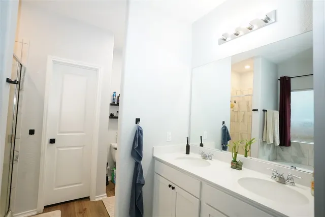 a bathroom with a double vanity sink and mirror