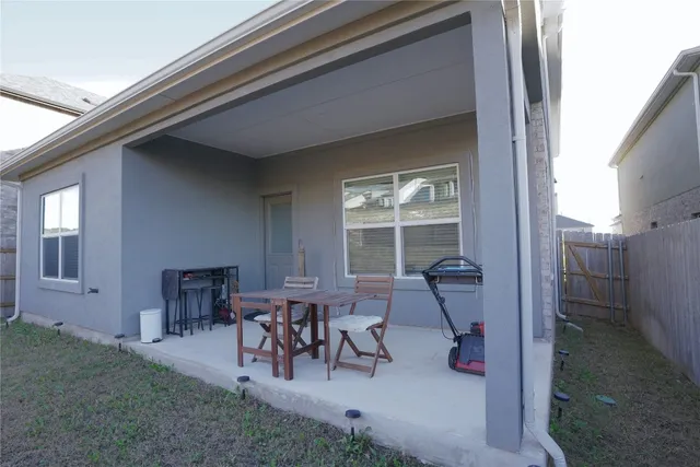 a view of dinning table and chairs in patio