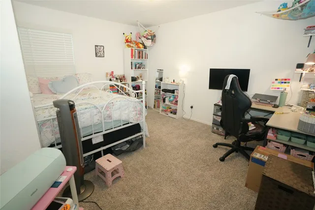 a bedroom with a workspace