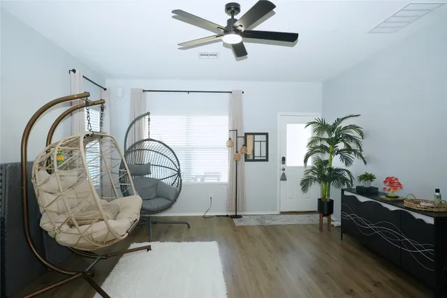 a living room with furniture and a potted plant