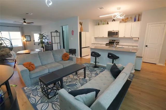 a living room with furniture and wooden floor