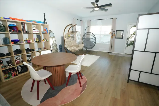 a view of a dining room with furniture and wooden floor