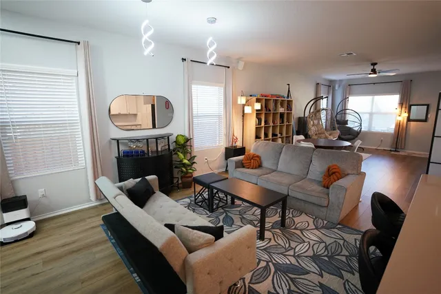 a living room with fireplace furniture and a wooden floor