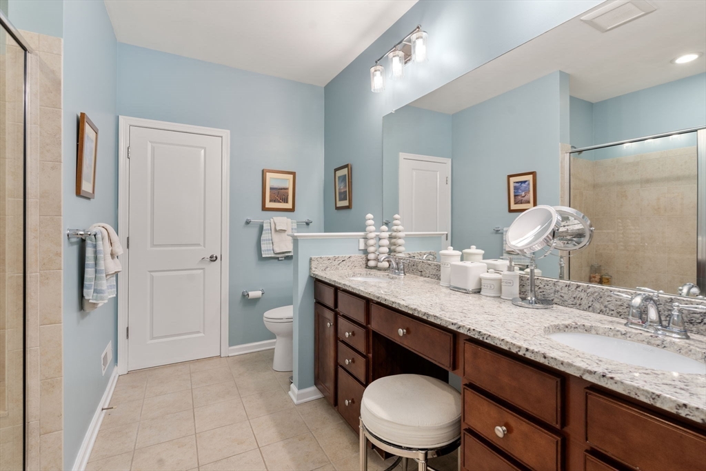 14 Iris Court, Unit 14 Canton, MA 02021 - Photo 17 of 42 a bathroom with a granite countertop sink a toilet and a mirror