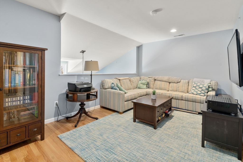 14 Iris Court, Unit 14 Canton, MA 02021 - Photo 23 of 42 a living room with furniture and a wooden floor