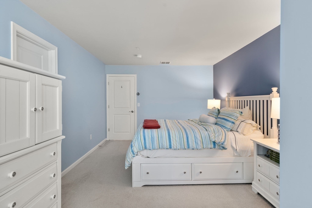 14 Iris Court, Unit 14 Canton, MA 02021 - Photo 25 of 42 a bedroom with furniture and baby crib
