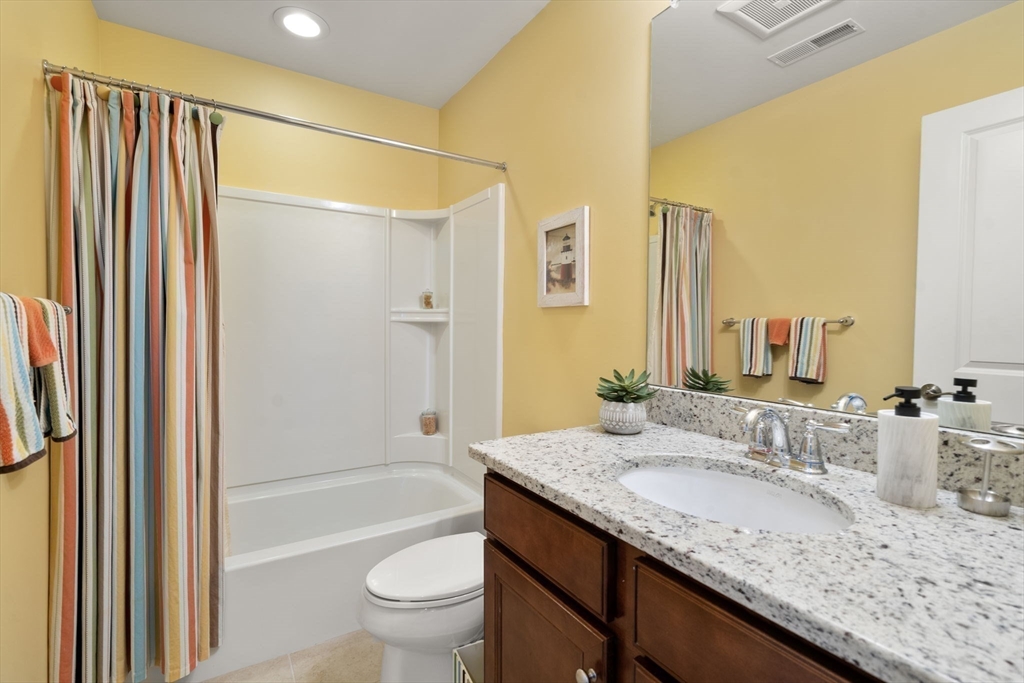 14 Iris Court, Unit 14 Canton, MA 02021 - Photo 26 of 42 a bathroom with a granite countertop sink and a mirror