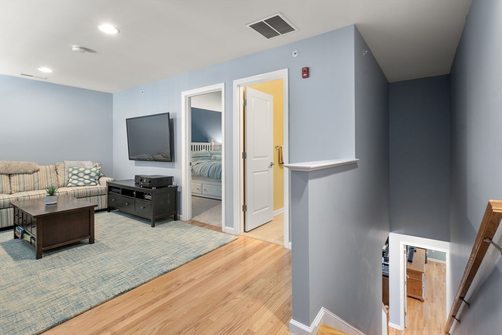 14 Iris Court, Unit 14 Canton, MA 02021 - Photo 27 of 42 a bedroom with furniture and a flat screen tv