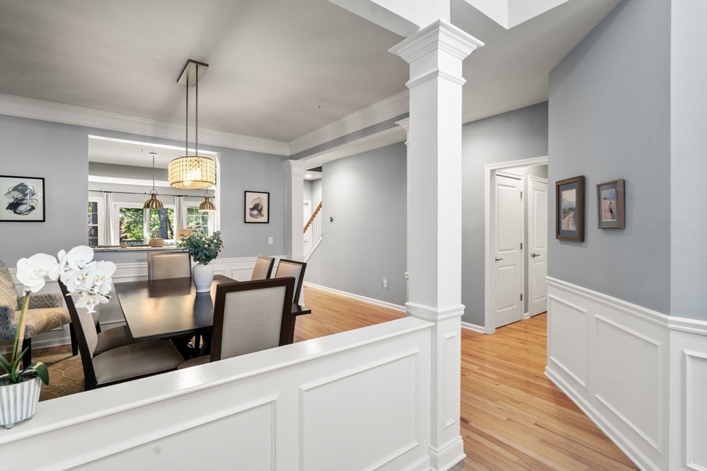 14 Iris Court, Unit 14 Canton, MA 02021 - Photo 4 of 42 a dining room with furniture a chandelier and wooden floor