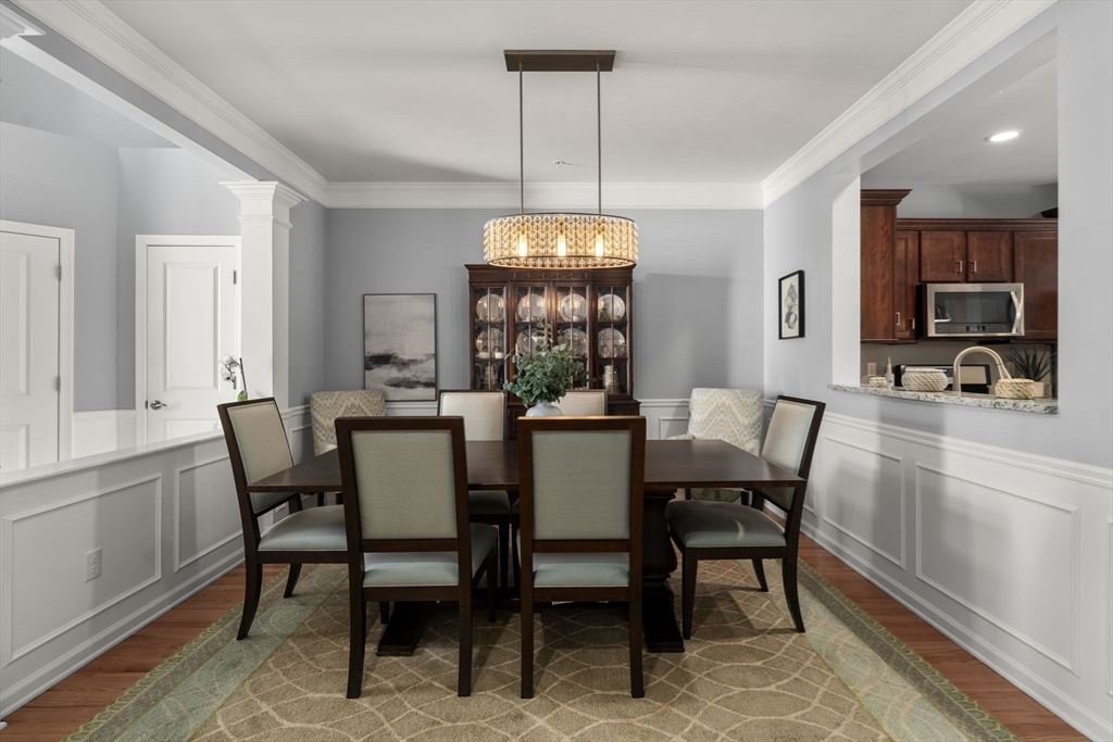 14 Iris Court, Unit 14 Canton, MA 02021 - Photo 5 of 42 a view of a dining room with furniture window and wooden floor