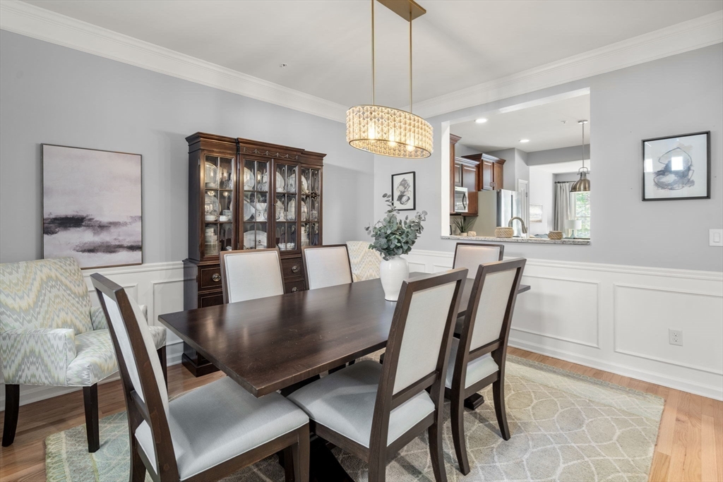 14 Iris Court, Unit 14 Canton, MA 02021 - Photo 6 of 42 a view of a dining room with furniture window and wooden floor