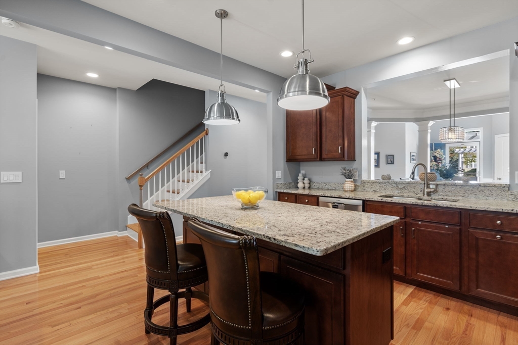 14 Iris Court, Unit 14 Canton, MA 02021 - Photo 10 of 42 a kitchen with a table chairs sink and wooden floor