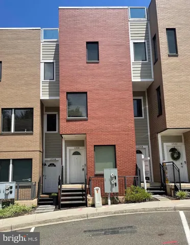 a front view of a house with a road