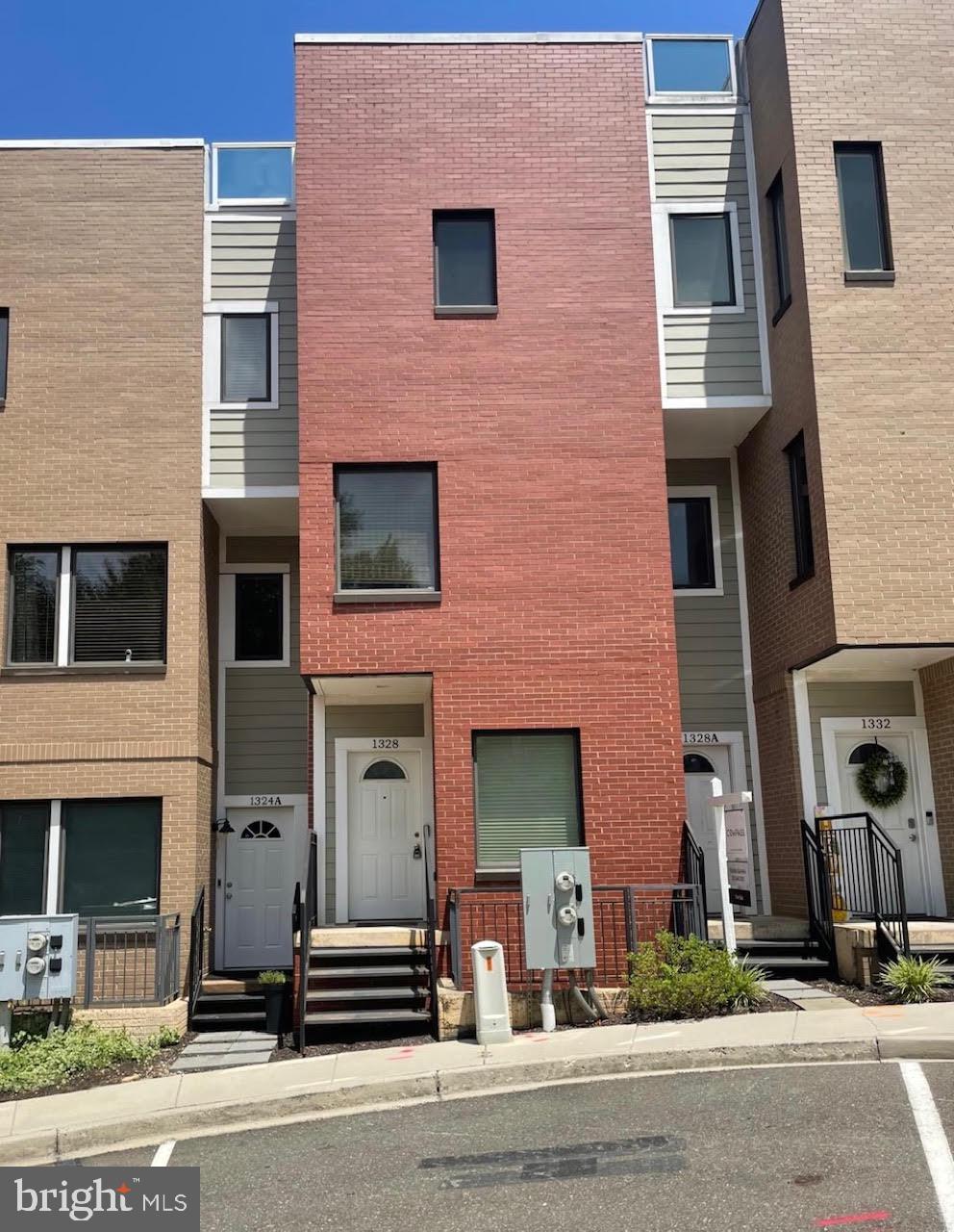 a front view of a house with a road