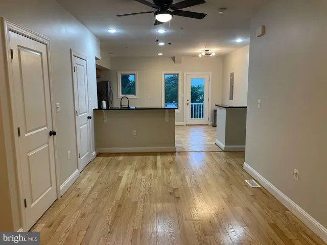 a view of empty room with wooden floor