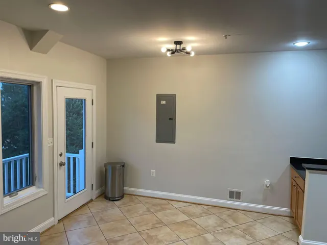 an empty room with chandelier fan