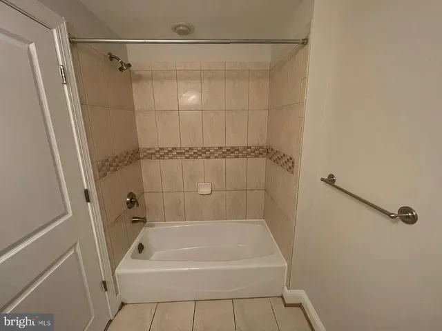 a bathroom with a shower and a bath tub