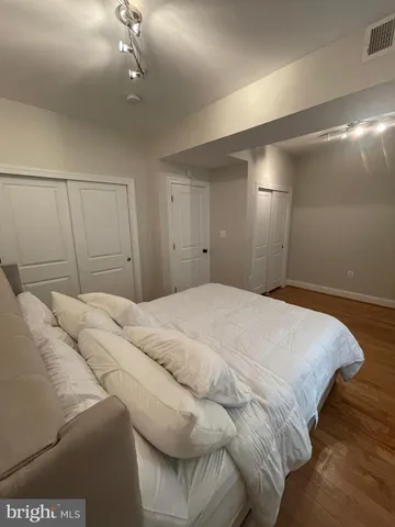 a bedroom with a bed and a night stand