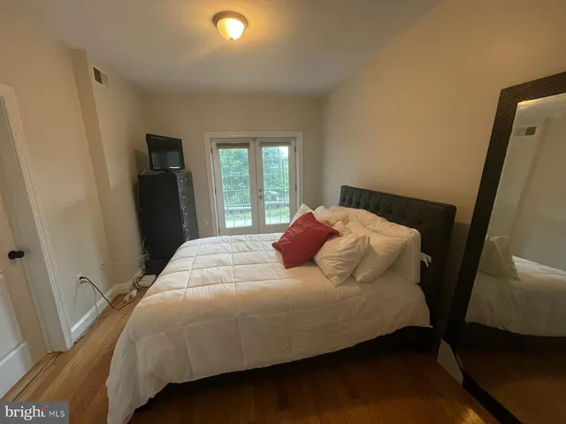 a bedroom with a bed and a mirror