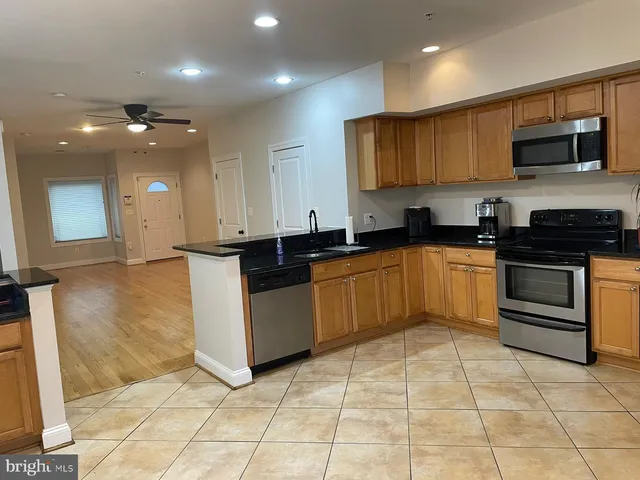 a kitchen with stainless steel appliances granite countertop a sink and cabinets
