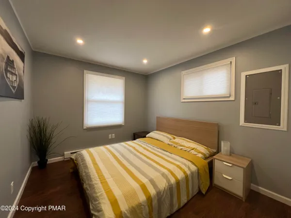 a bedroom with a bed and a night stand