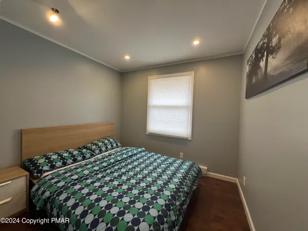 a bedroom with bed and a window