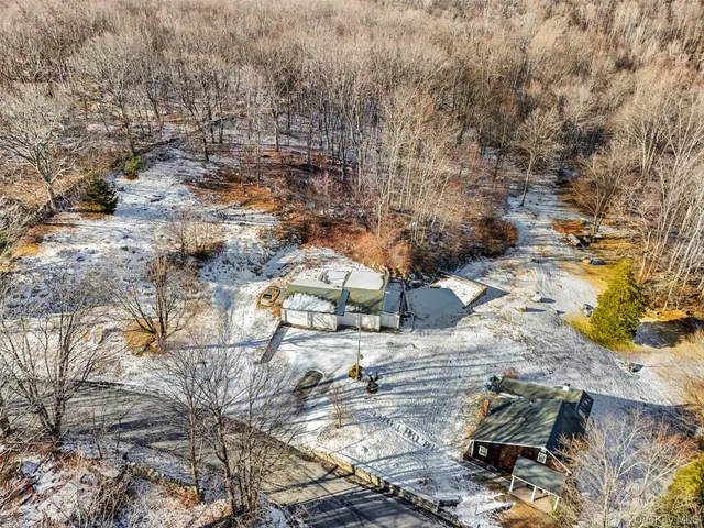 a view of residential houses with yard and mountain view in back