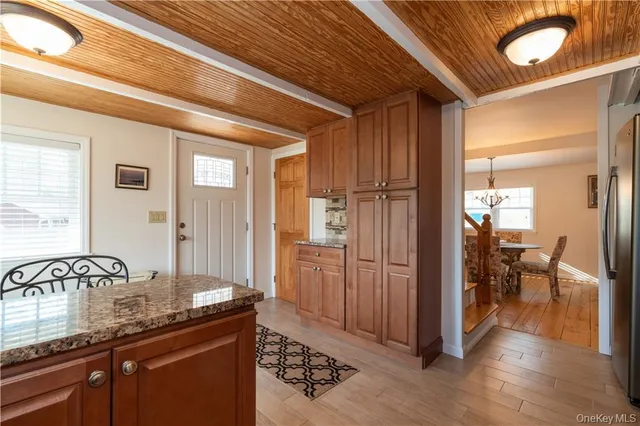 a view of a hallway and dining room with wooden floor