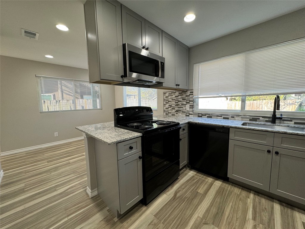 12804 Copper Cliff Avenue, Unit B Austin, TX 78727 - Photo 12 of 29 a kitchen with a stove and a sink