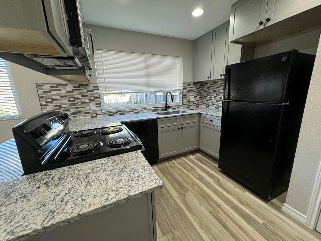 12804 Copper Cliff Avenue, Unit B Austin, TX 78727 - Photo 13 of 29 a kitchen with a sink stove and refrigerator