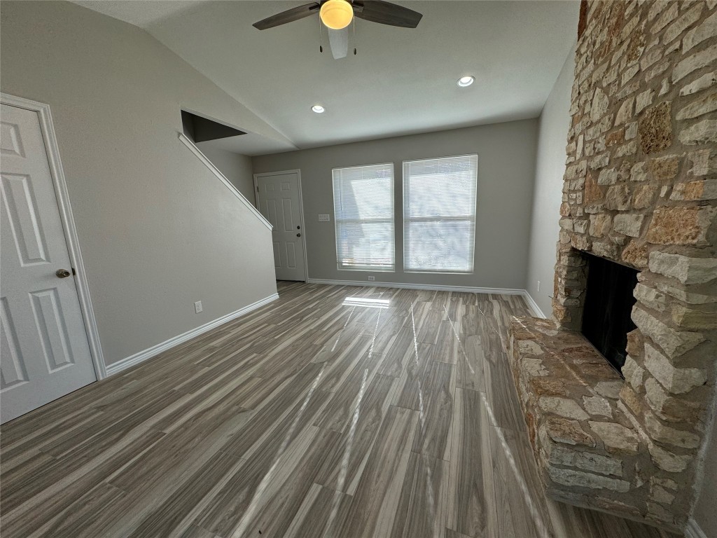 12804 Copper Cliff Avenue, Unit B Austin, TX 78727 - Photo 2 of 29 wooden floor in an empty room with a fireplace