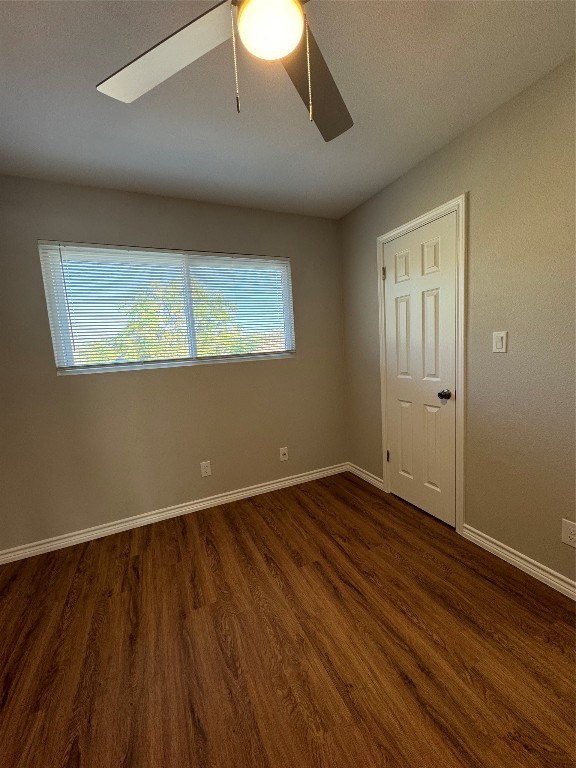 12804 Copper Cliff Avenue, Unit B Austin, TX 78727 - Photo 21 of 29 a view of an empty room with wooden floor and a window