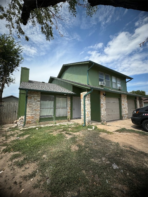 12804 Copper Cliff Avenue, Unit B Austin, TX 78727 - Photo 28 of 29 a front view of a house with a yard and garage