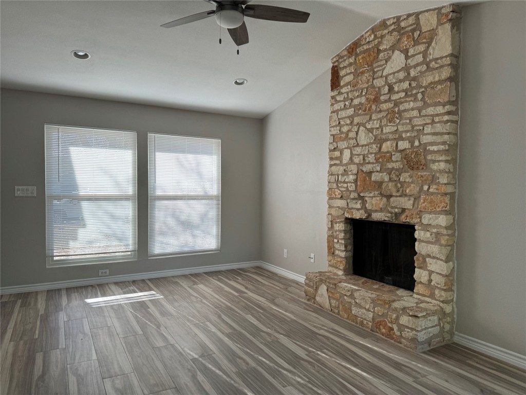 12804 Copper Cliff Avenue, Unit B Austin, TX 78727 - Photo 4 of 29 an empty room with windows and fireplace