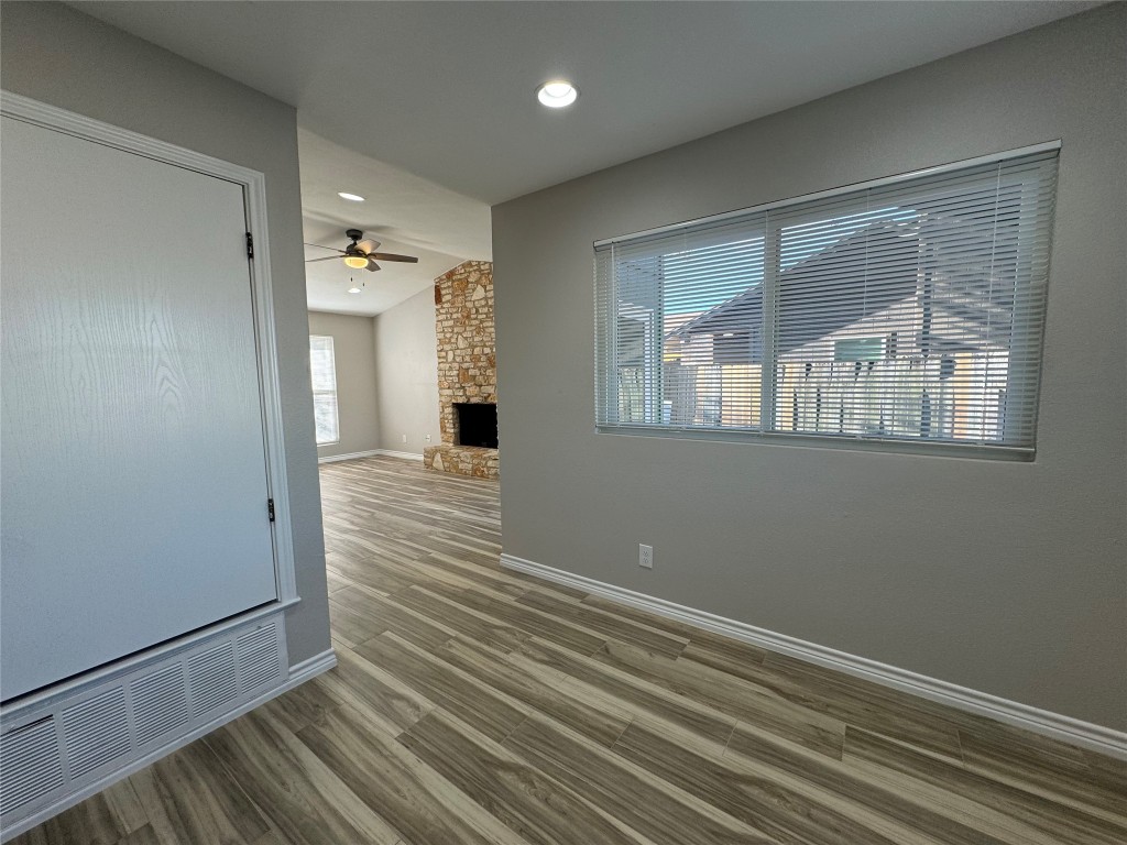 12804 Copper Cliff Avenue, Unit B Austin, TX 78727 - Photo 6 of 29 a view of an empty room with wooden floor and a window