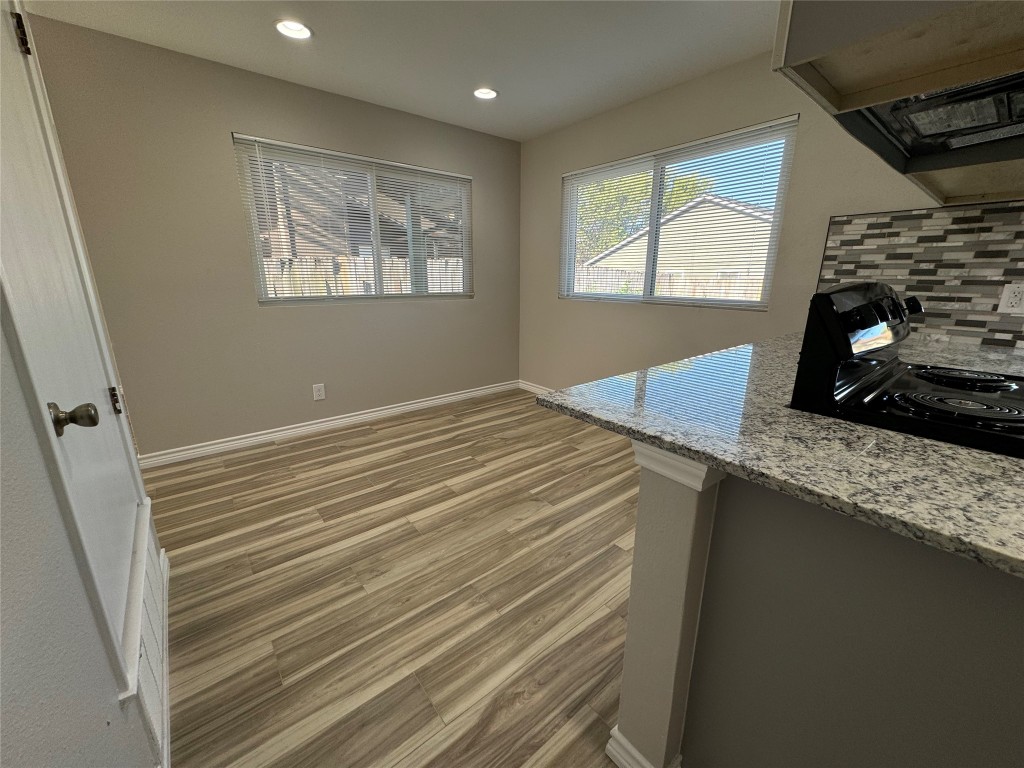 12804 Copper Cliff Avenue, Unit B Austin, TX 78727 - Photo 8 of 29 a view of a kitchen cabinets a sink and wooden floor