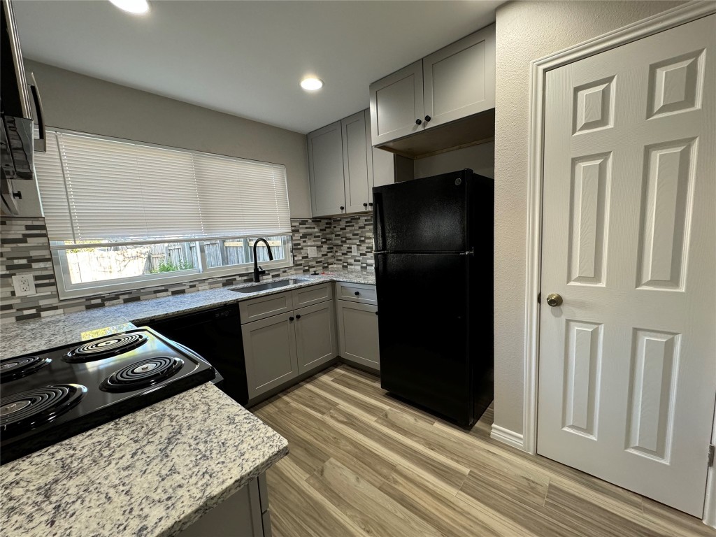 12804 Copper Cliff Avenue, Unit B Austin, TX 78727 - Photo 9 of 29 a kitchen with a sink stove and refrigerator