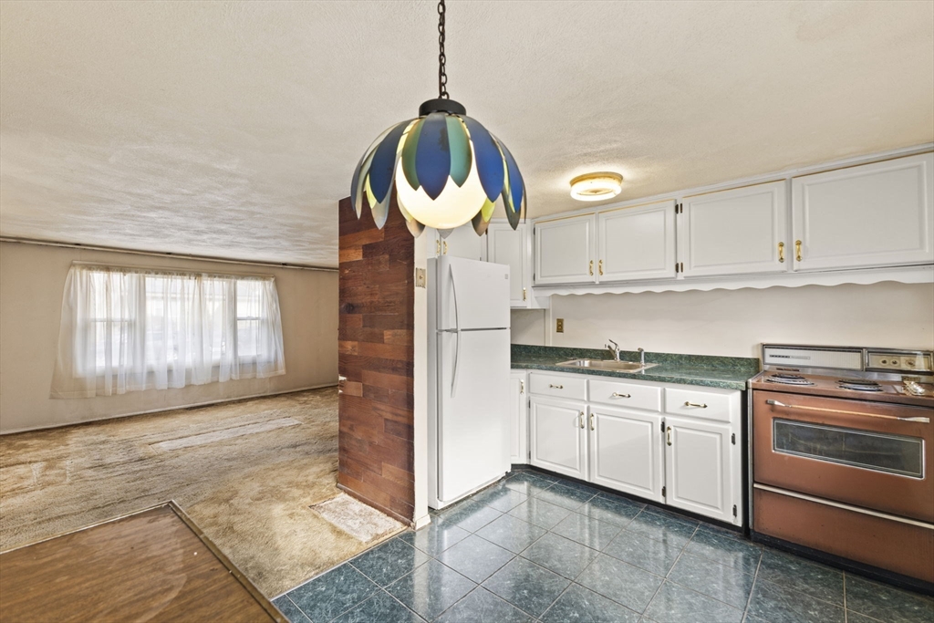 2 Alwin Street Boston, MA 02136 - Photo 15 of 43 a kitchen with granite countertop white cabinets and white appliances