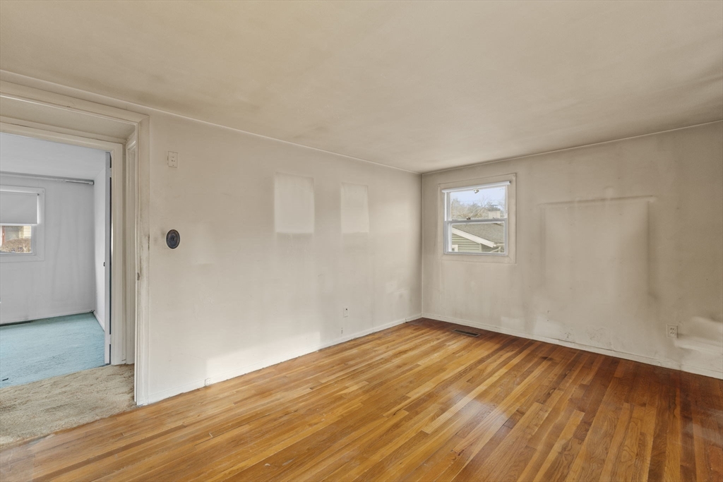 2 Alwin Street Boston, MA 02136 - Photo 20 of 43 an empty room with wooden floor and windows