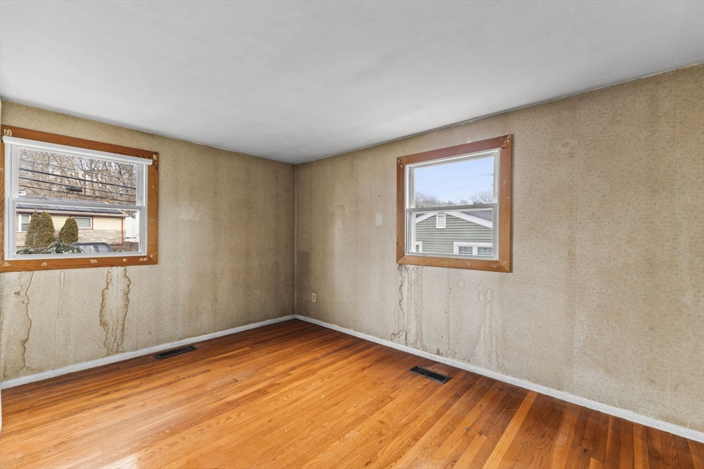 2 Alwin Street Boston, MA 02136 - Photo 23 of 43 a view of an empty room with wooden floor and a window