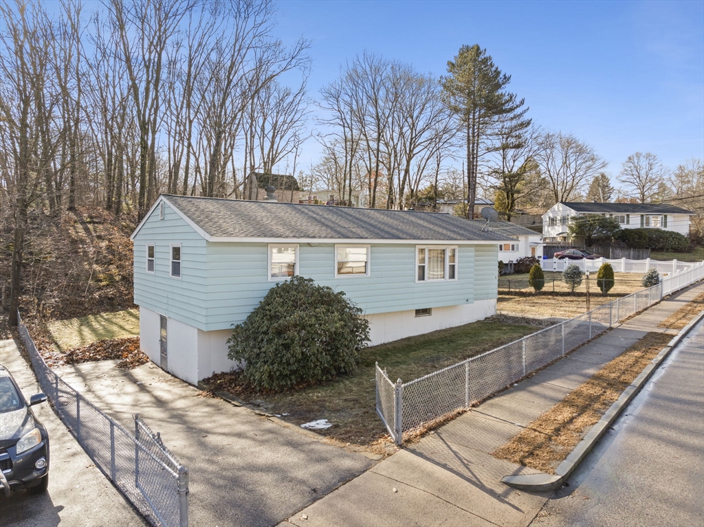 2 Alwin Street Boston, MA 02136 - Photo 5 of 43 a front view of a house with a yard and garage