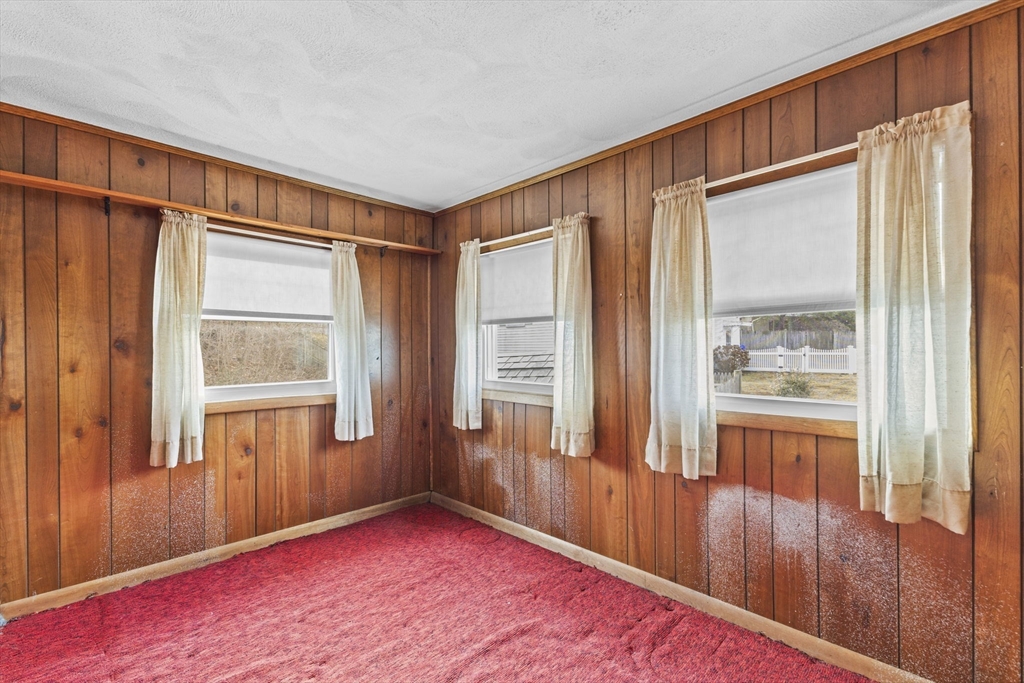 2 Alwin Street Boston, MA 02136 - Photo 9 of 43 a view of an empty room with wooden floor and a window