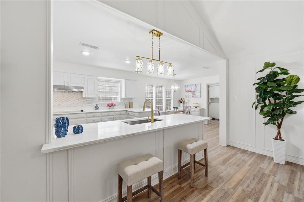 5808 Ridge Drive Arlington, TX 76016 - Photo 11 of 40 a kitchen with stainless steel appliances a sink a stove a dining table and chairs