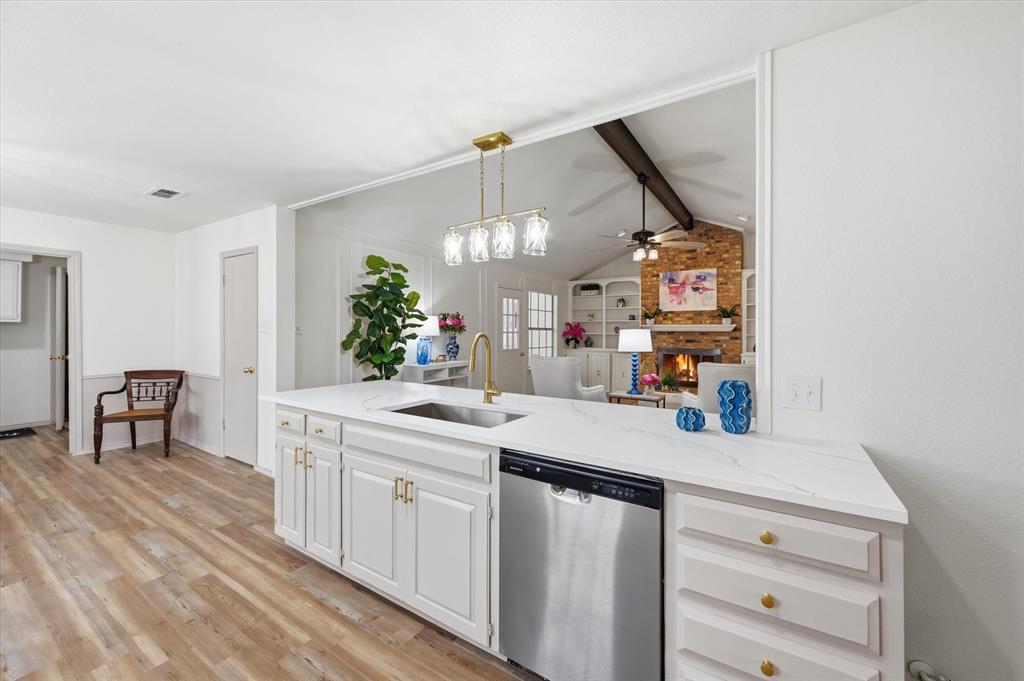 5808 Ridge Drive Arlington, TX 76016 - Photo 13 of 40 a kitchen with a sink cabinets and wooden floor