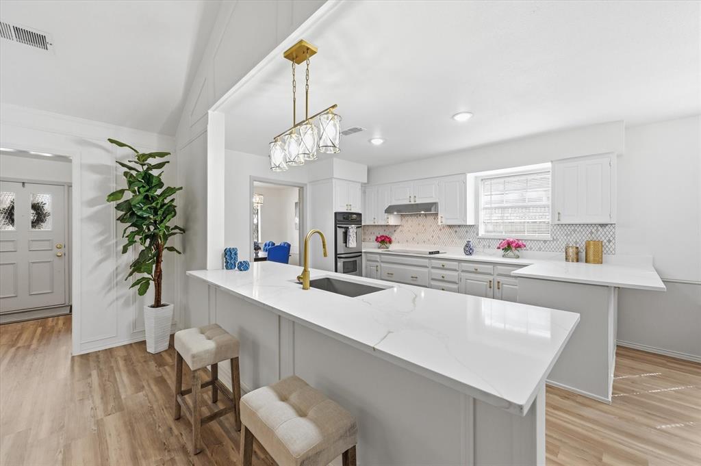 5808 Ridge Drive Arlington, TX 76016 - Photo 16 of 40 a large white kitchen with granite countertop a counter space a sink and appliances