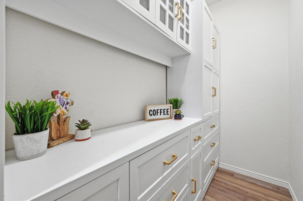 5808 Ridge Drive Arlington, TX 76016 - Photo 18 of 40 a kitchen with a potted plant on the counter and a wooden floor