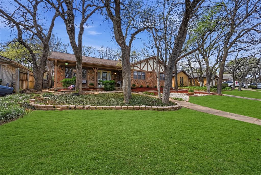 5808 Ridge Drive Arlington, TX 76016 - Photo 3 of 40 a view of a house with a big yard and palm trees